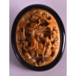 A 19TH CENTURY CHINESE CARVED CANTON IVORY BROOCH depicting figures within a landscape. 1.5ins x 2.