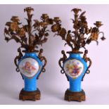 A PAIR OF 19TH CENTURY FRENCH SEVRES PORCELAIN VASES converted to candelabra, painted with putti