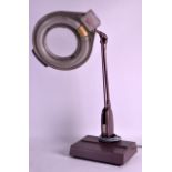 A RETRO AMERICAN ILLUMINATED BENCH MAGNIFIER LAMP with adjustable neck. 1Ft 11ins high.