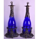 A PAIR OF SILVER PLATED BLUE GLASS BOTTLES AND STOPPERS in the Victorian manner, with acanthus