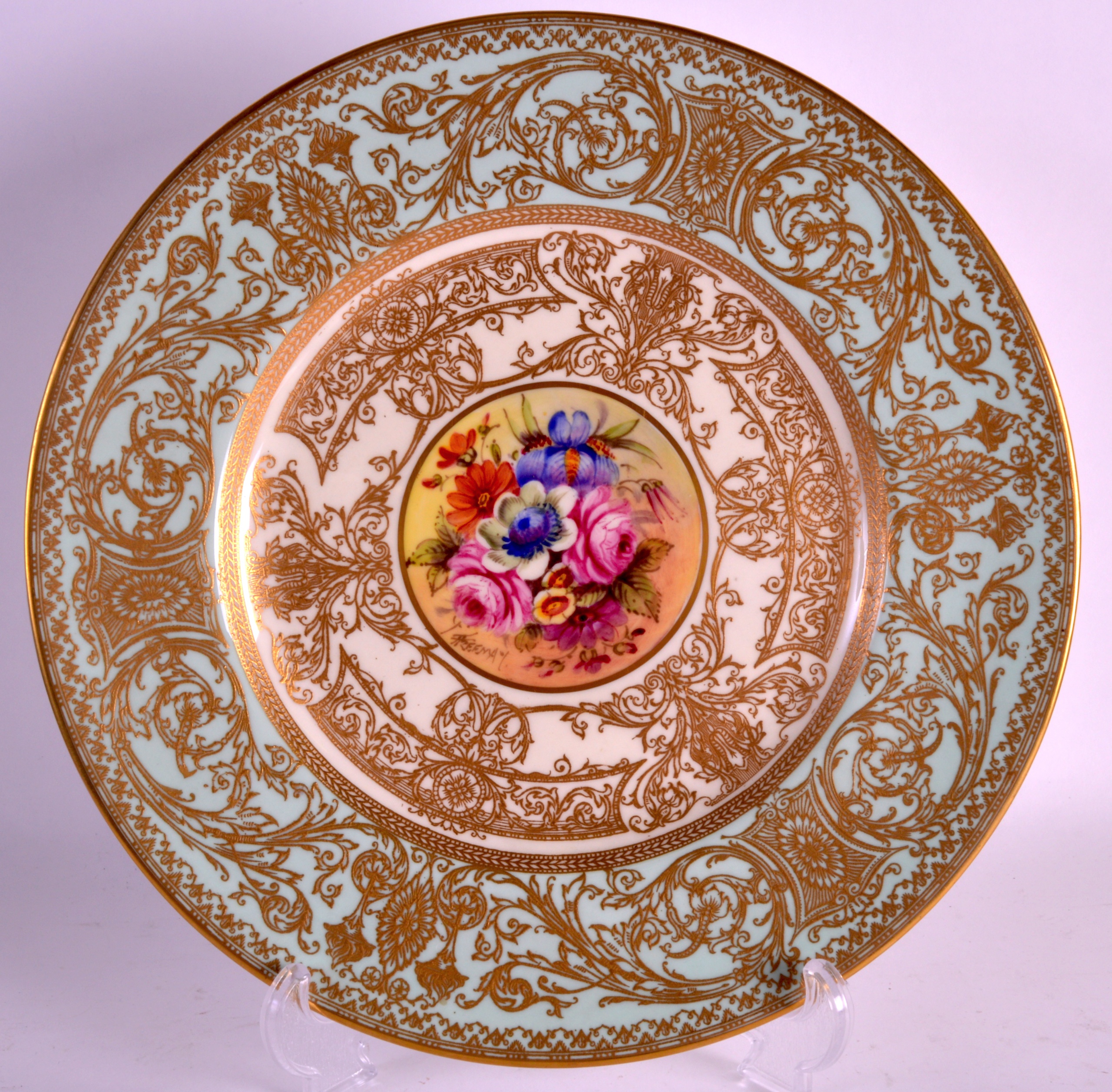 A ROYAL WORCESTER CABINET PLATE by John Freeman, painted with a central floral spray within a gilt