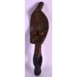 AN UNUSUAL AFRICAN CARVED WOOD BRASS BOUND TRIBAL FIGURE. 9.5ins long.