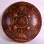 AN EARLY 20TH CENTURY RAJASTHAN PAINTED LACQUER SHIELD depicting animals and figures within a