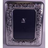 AN ITALIAN SILVER PHOTOGRAPH FRAME with embossed flowers. Overall 10.5ins x 8.25ins.