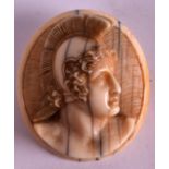 A 19TH CENTURY EUROPEAN CARVED IVORY BROOCH decorated with a central portrait of a Roman warrior,