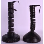 A MATCHED PAIR OF 18TH CENTURY 'PIG TAIL' CANDLESTICKS. 8Ins high.