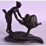 AN ART NOUVEAU PEWTER CANDLESTICK modelled as a female holding open a flower. Signed Kinsburger. 5.