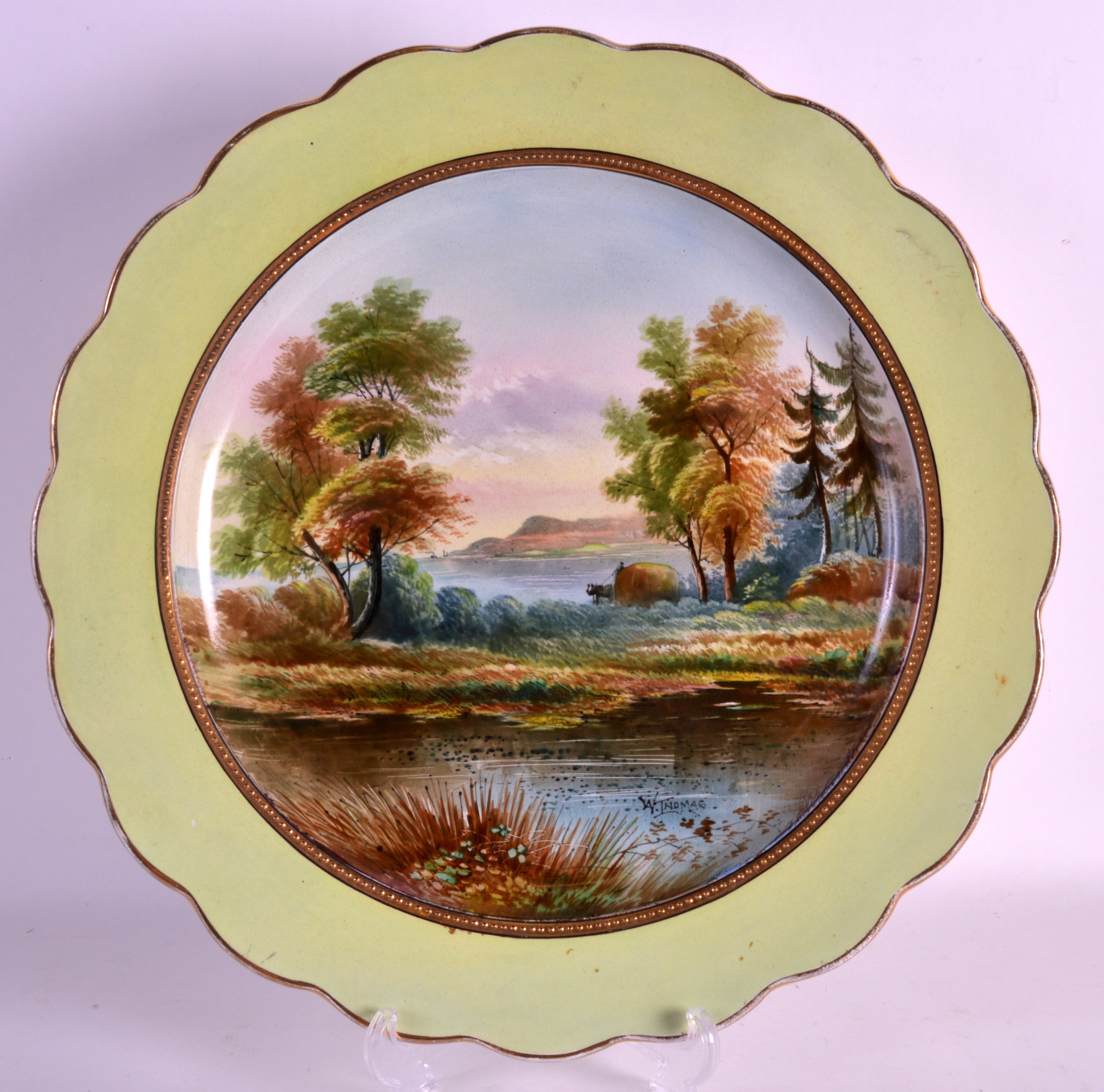 A MID 19TH CENTURY ENGLISH POTTERY CHARGER painted with a coastal landscape by Thomas. 1Ft 3ins