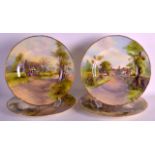 A SET OF FOUR ROYAL WORCESTER CABINET PLATES decorated with landscapes by N Nicholls, two others