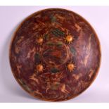 AN EARLY 20TH CENTURY RAJASTHAN PAINTED LACQUER SHIELD depicting animals and figures within a