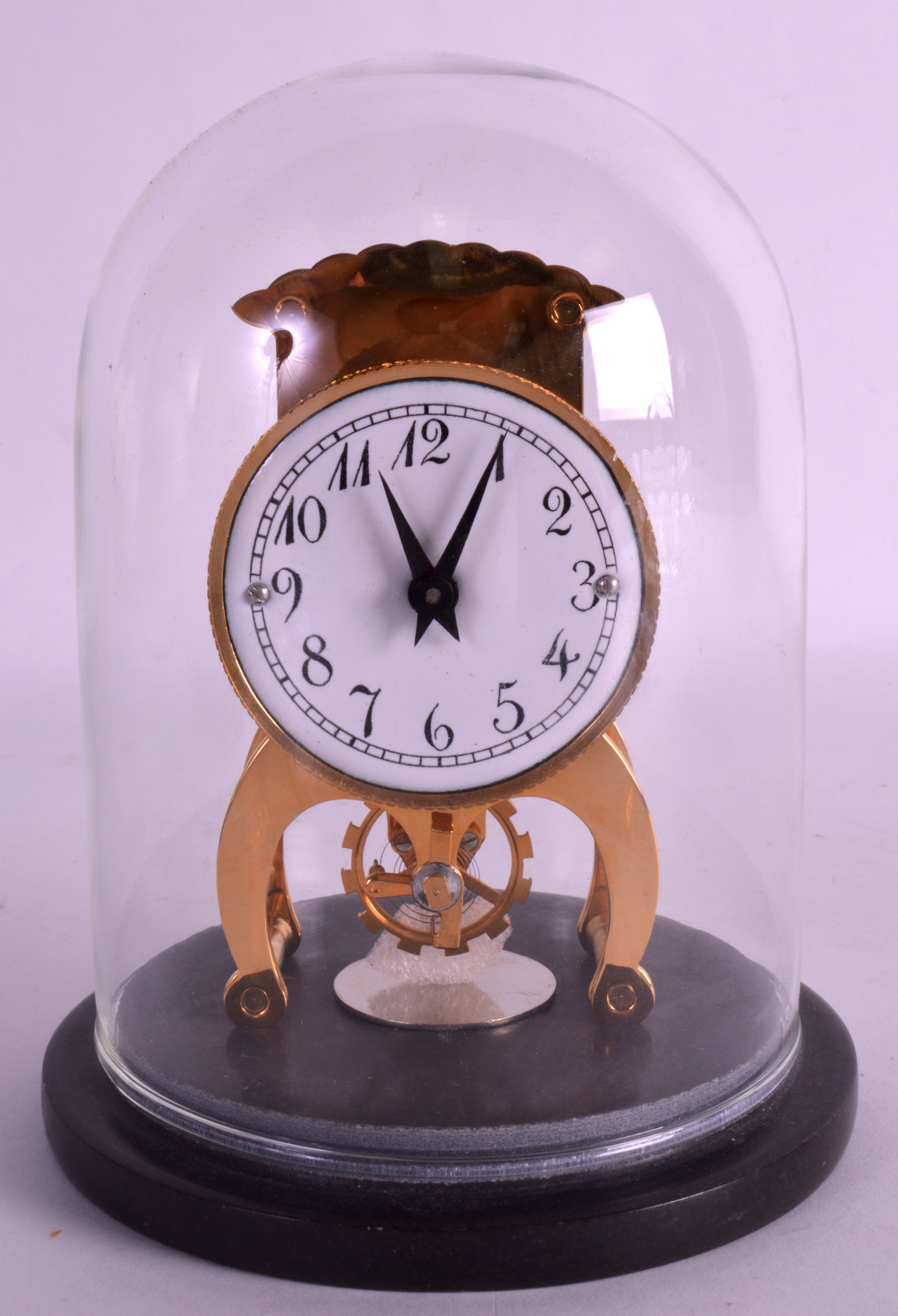 A BRASS DOME CASED MANTEL CLOCK. 6Ins high.