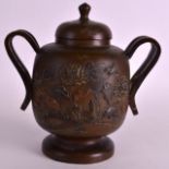 A 19TH CENTURY JAPANESE MEIJI PERIOD TWIN HANDLED BRONZE CENSER AND COVER decorated with flowers and