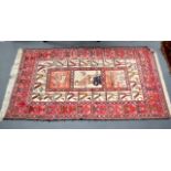 A 20TH CENTURY SOUMAC VILLAGE RUG decorated with tribal motifs upon a white ground. 6Ft 4ins x 4ft.