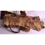 AN EARLY 20TH CENTURY LEOPARD SKIN together with two fur coats. (3)