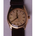 A 1950S ROLEX GENTLEMANS 18CT ROLEX OYSTER PERPETUAL WRISTWATCH with cream dial and gold numerals.