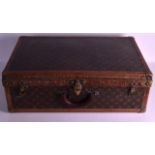 A VINTAGE LOUIS VUITTON TRUNK with brass lock plate and leather banding. No. 057995. 2ft 1ins wide.