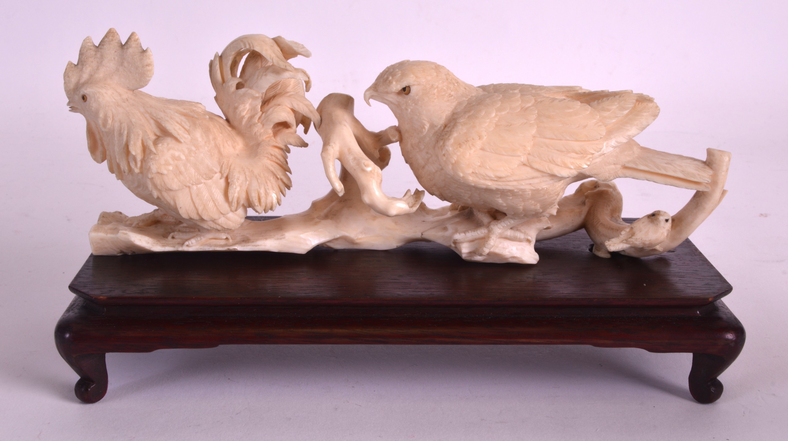 A 19TH CENTURY JAPANESE MEIJI PERIOD CARVED IVORY OKIMONO modelled as a game bird  standing behind a