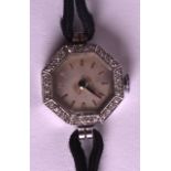 AN ART DECO PLATINUM AND DIAMOND LADIES COCKTAIL WATCH with octagonal face. 1.25ins wide.