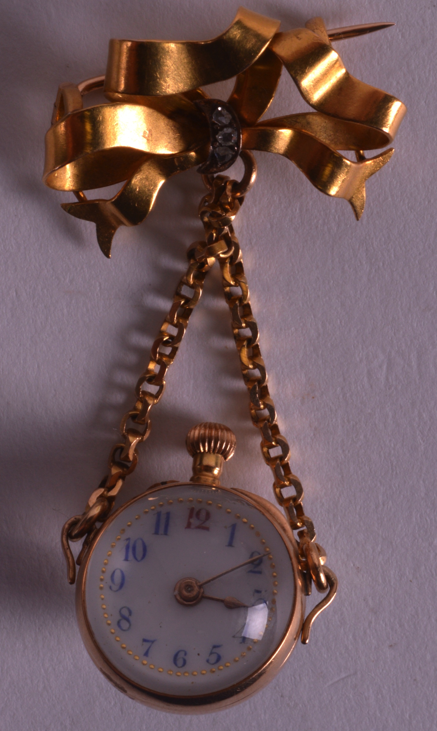 AN EDWARDIAN LADIES GOLD REVERSE FOB WATCH carved with an Essex crystal flower.