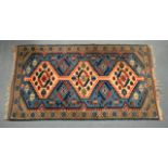 A MID 20TH CENTURY SMALL NORTH WEST PERSIAN VILLAGE RUG decorated on a pale blue ground. 3Ft 10ins x