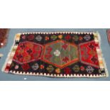 A MID 20TH CENTURY EUROPEAN RUG decorated with motifs. 4Ft 5ins x 2ft 10ins.