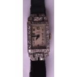 AN ART DECO 18CT WHITE GOLD AND DIAMOND LADIES COCKTAIL WATCH by Benson. 0.5ins wide.