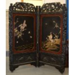 A LATE 19TH CENTURY JAPANESE MEIJI PERIOD BLACK LACQUER SCREEN decorated in relief with birds