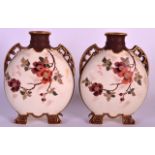 A PAIR OF LATE 19TH CENTURY AESTHETIC MOVEMENT FLASKS painted with flowers upon a blush ivory