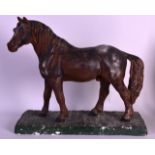 AN UNUSUAL EARLY 20TH CENTURY PAINTED PLASTER MODEL OF A HORSE depicted upon a rectangular green