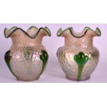 A PAIR OF EARLY 20TH CENTURY IRIDESCENT GLASS VASES well formed with green overlaid vines. 6.5ins