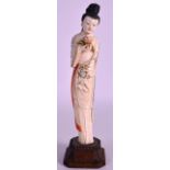 AN EARLY 20TH CENTURY CHINESE CARVED IVORY FIGURE OF A FEMALE with partial polychrome and