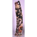 A LARGE EARLY 20TH CENTURY CHINESE CARVED POLYCHROMED IVORY FIGURE modelled as a standing scholar