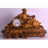 A FINE 19TH CENTURY FRENCH ORMOLU MANTEL CLOCK modelled as a reclining female holding an open