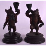 A PAIR OF EARLY 20TH CENTURY COLD PAINTED SPELTER CANDLESTICKS formed as a bear & fox. 7.75ins