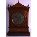 A LARGE REGENCY MAHOGANY BRACKET CLOCK on gongs, inlaid with brass foliage, the silvered dial