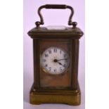 A SMALL LATE 19TH CENTURY FRENCH BRASS CARRIAGE CLOCK with white enamel dial. 3.25ins high.
