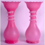 A PAIR OF VICTORIAN PINK GLASS VASES with coiled snakes to the neck. 10.5ins high.