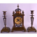 A 19TH CENTURY FRENCH CHAMPLEVE ENAMEL CLOCK GARNITURE decorated with floral scrolls and vines,