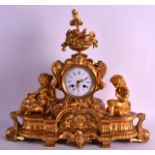 A 19TH CENTURY FRENCH ORMOLU MANTEL CLOCK surmounted with two young females, the top bearing a an