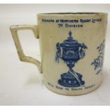 OF RUGBY LEAGUE INTEREST - a pottery mug of plain cylindrical form, printed in underglaze blue