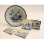 AN ENGLISH DELFT SMALL CHARGER, late 18th century, of plain circular form, centrally painted with
