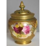 A ROYAL WORCESTER PORCELAIN POT POURRI VASE AND COVER, 1923, of ovoid form, the gilded and pierced