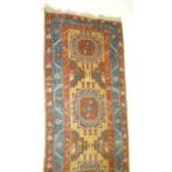 A PERSIAN RUNNER, the camel field with repeating large gul pattern, sky blue main border with