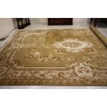 A CHINESE WASHED AND FRINGED CARPET, the champagne field with ivory floral gul, within a similar