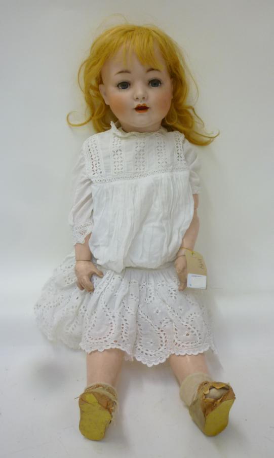 A German bisque head character doll, possibly Konig & Wernicke, with blue glass sleeping eyes,