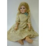 A Schoenau & Hoffmeister bisque head girl doll with blue glass sleeping eyes, open mouth and