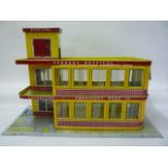 A Mettoy type "Emergency Ward 10" toy hospital, tinplate, two storey, swivel plastic windows, lift