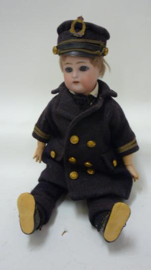 A Kammer & Rheinhardt bisque head doll with blue glass sleeping eyes, open mouth and teeth,