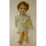 A Gebruder Heubach bisque head character doll with brown glass sleeping eyes, open mouth and