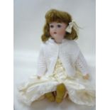 A Kammer & Reinhardt bisque head girl doll with blue glass sleeping eyes, open mouth and teeth,